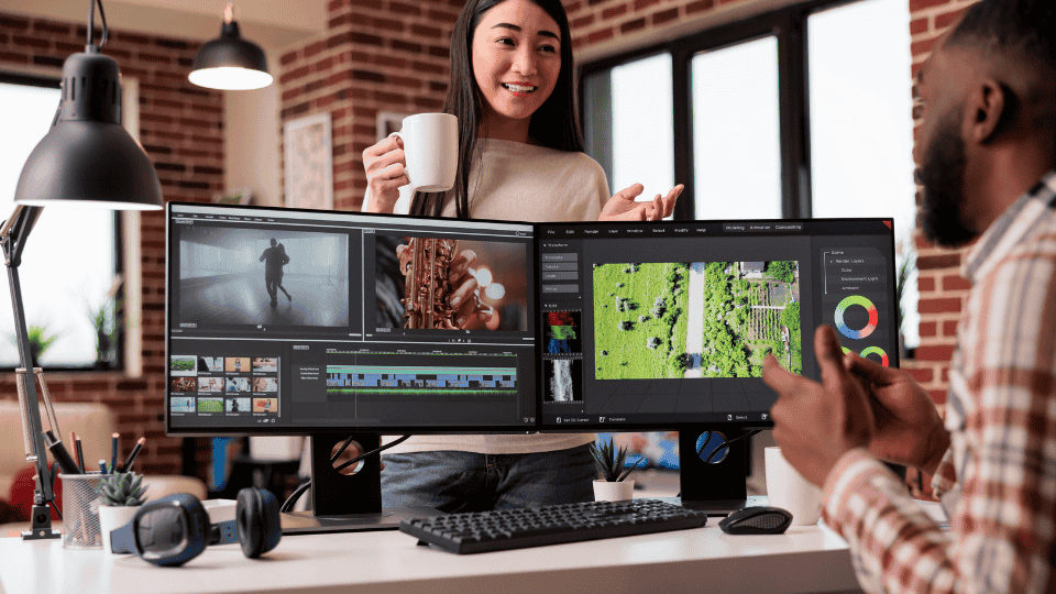 Video production in progress with two professionals reviewing footage on dual monitors.